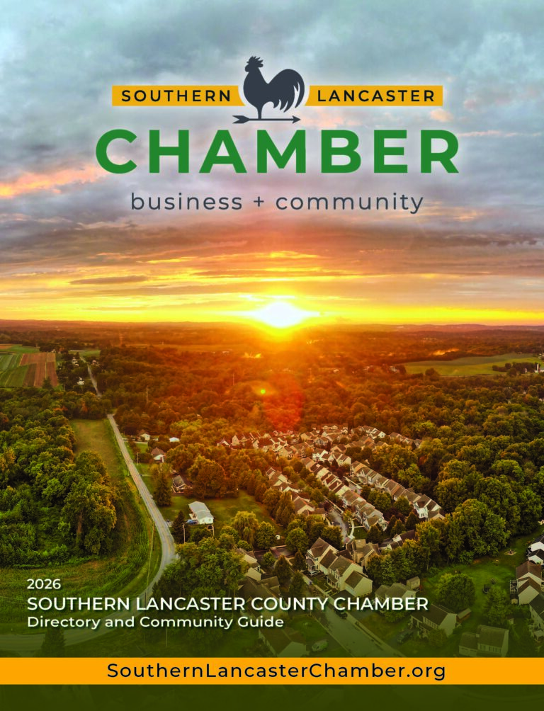 An overhead drone image of southern lancaster county at sunset with homes, trees, and clouds