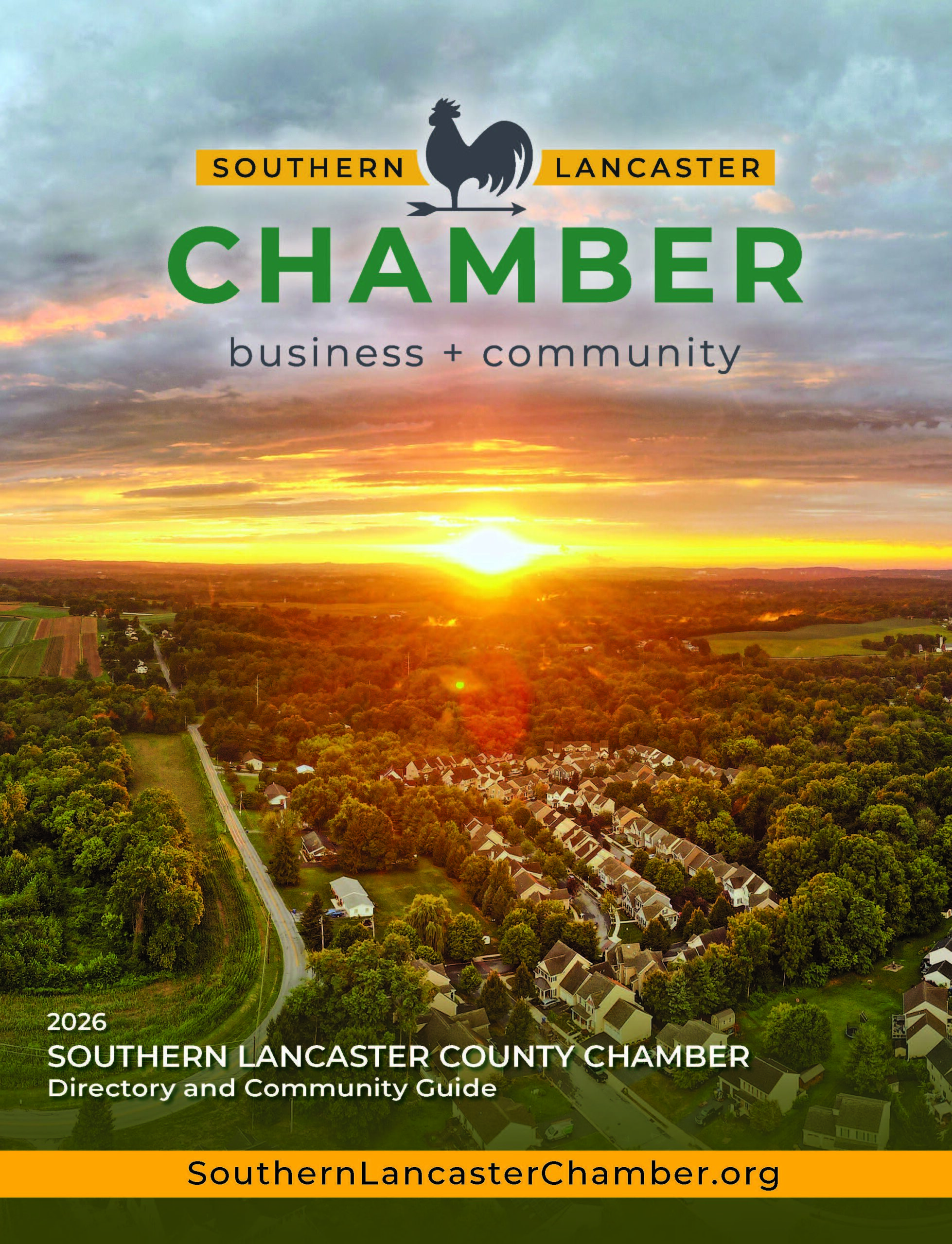 An overhead drone image of southern lancaster county at sunset with homes, trees, and clouds